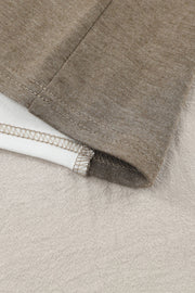 Colorblock knit top in tan showing seam detail and contrasting fabric.