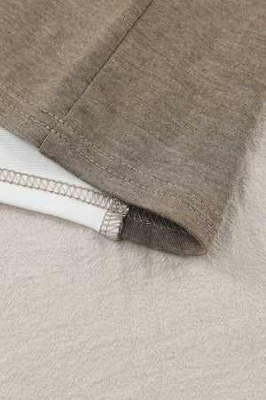 Colorblock knit top in tan showing seam detail and contrasting fabric.