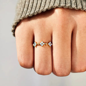 Gold celestial blossom band ring with blue stone accents