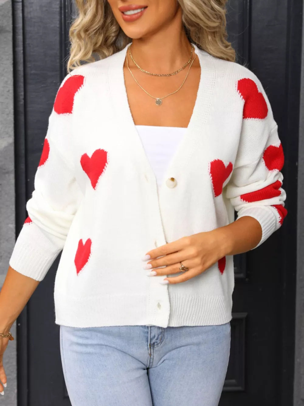 White acrylic knit cardigan with red heart pattern, button front, V-neck.