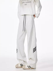 Light gray relaxed fit sweatpants with drawstring and black side stripes