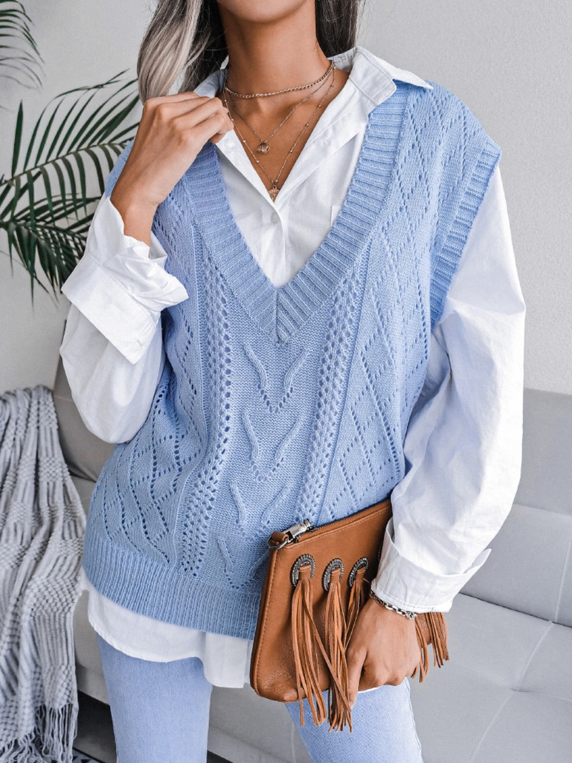 Light blue openwork cable knit vest with V-neck and diamond pattern, acrylic.