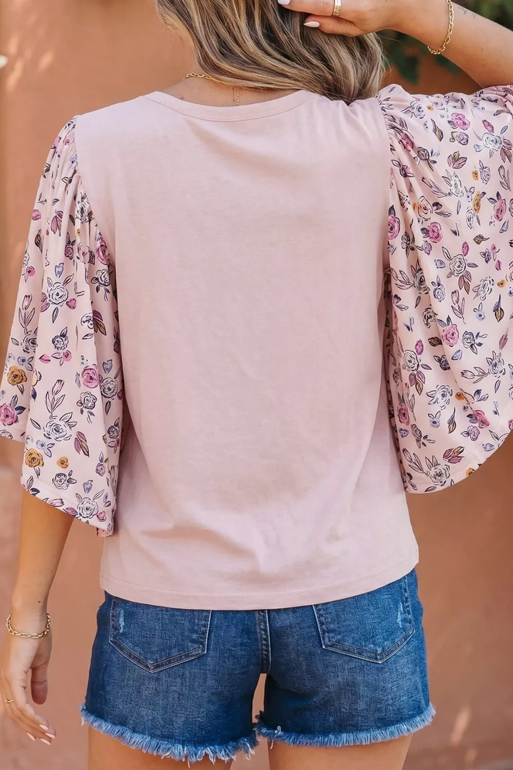 Maternity crew neck shirt in pink with floral patchwork sleeves.