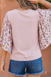 Maternity crew neck shirt in pink with floral patchwork sleeves.
