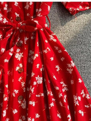 Red floral midi dress with button front, belted waist, and V-neck detail.