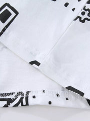 White cotton kids' t-shirt with black geometric construction vehicle print and stitched hem.
