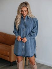 Medium wash denim oversized shirtdress with button front, side slits, and pocket detail.