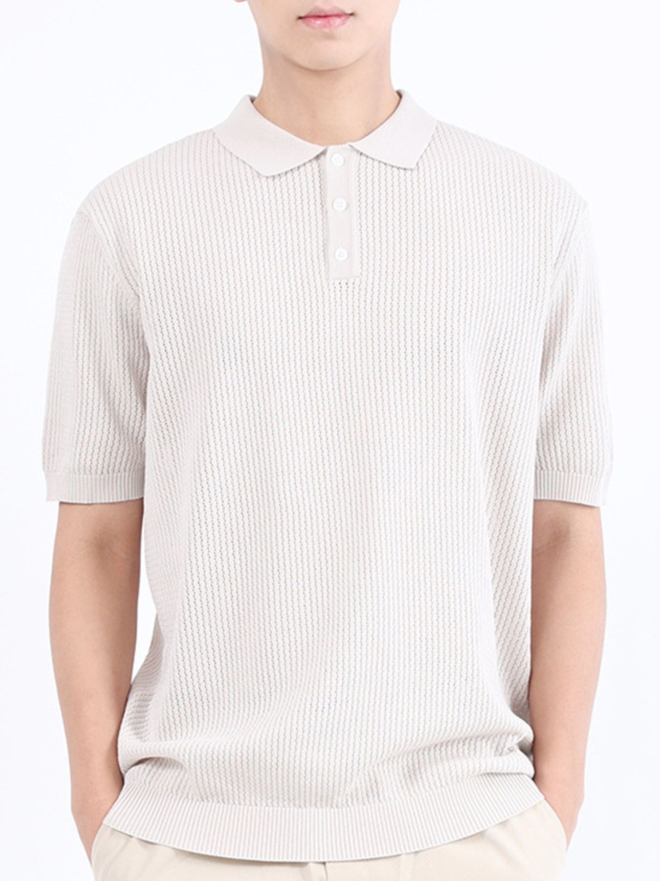 Beige textured knit polo shirt with classic collar and short sleeves.