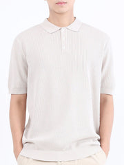 Beige textured knit polo shirt with classic collar and short sleeves.