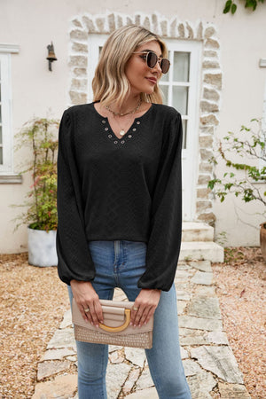 Black eyelet yoke blouse with blouson sleeves and v-neckline