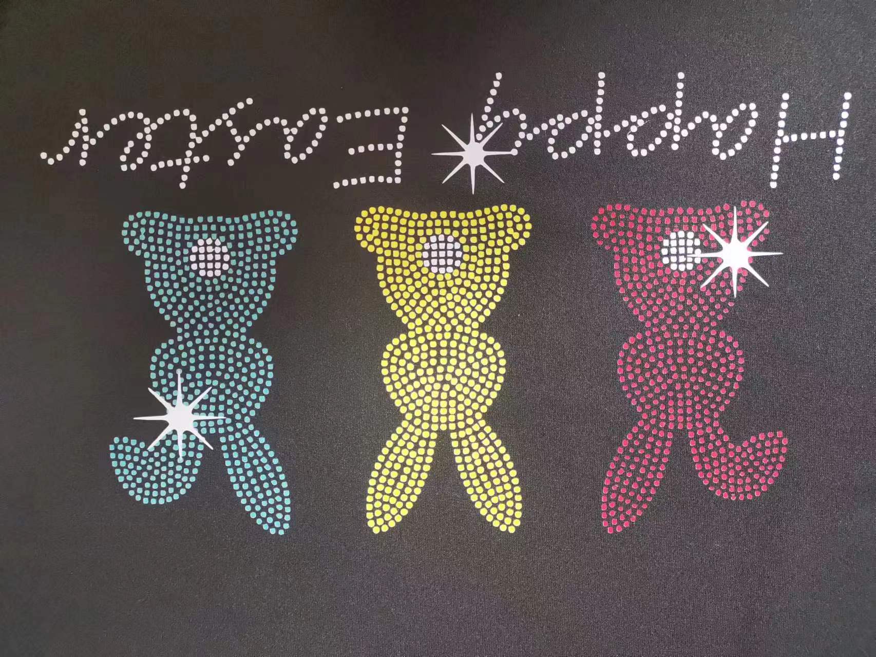 Black t-shirt with rhinestone Easter bunnies and Happy Easter text.
