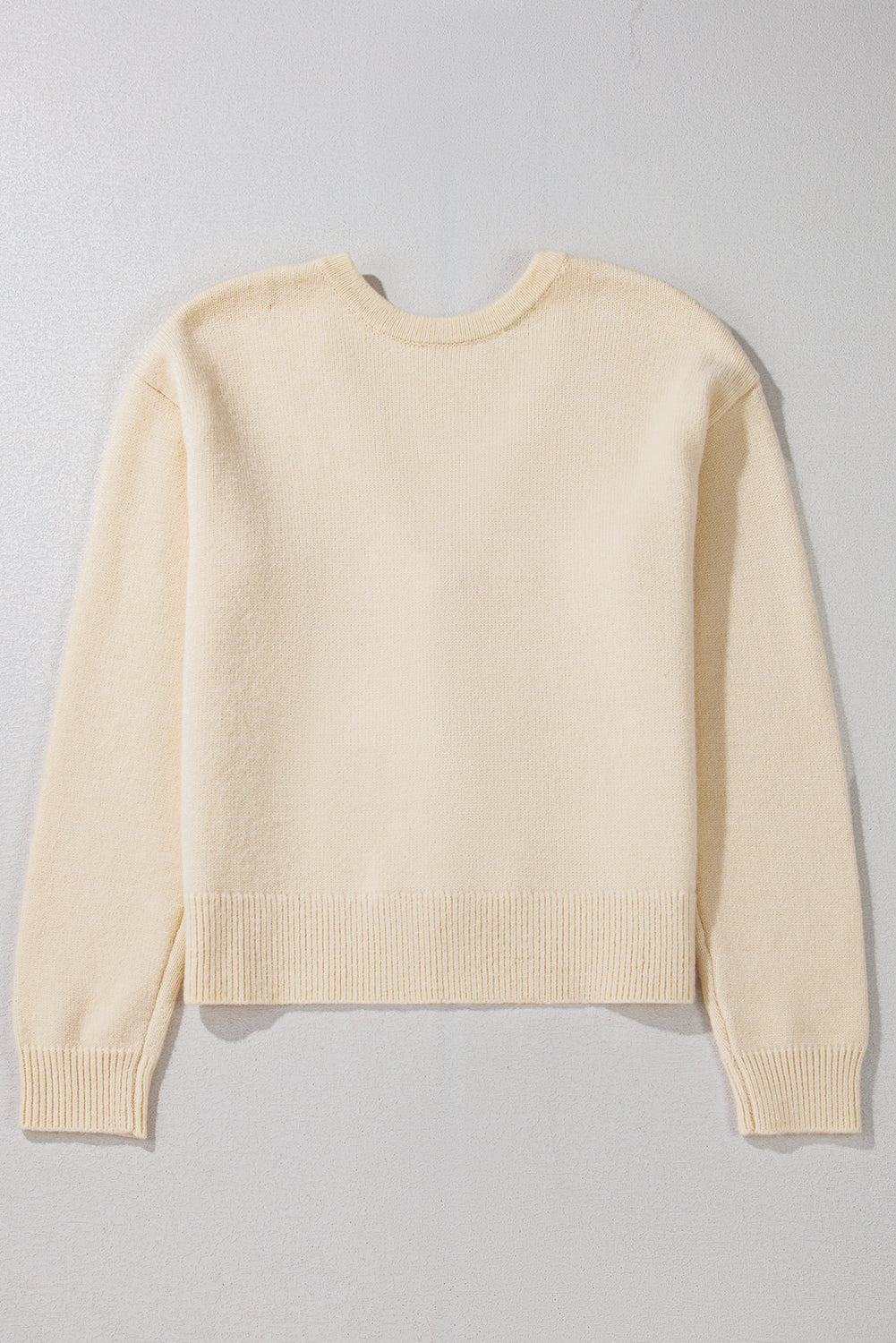Ivory bouclé knit cardigan with crewneck and ribbed cuffs and hem.