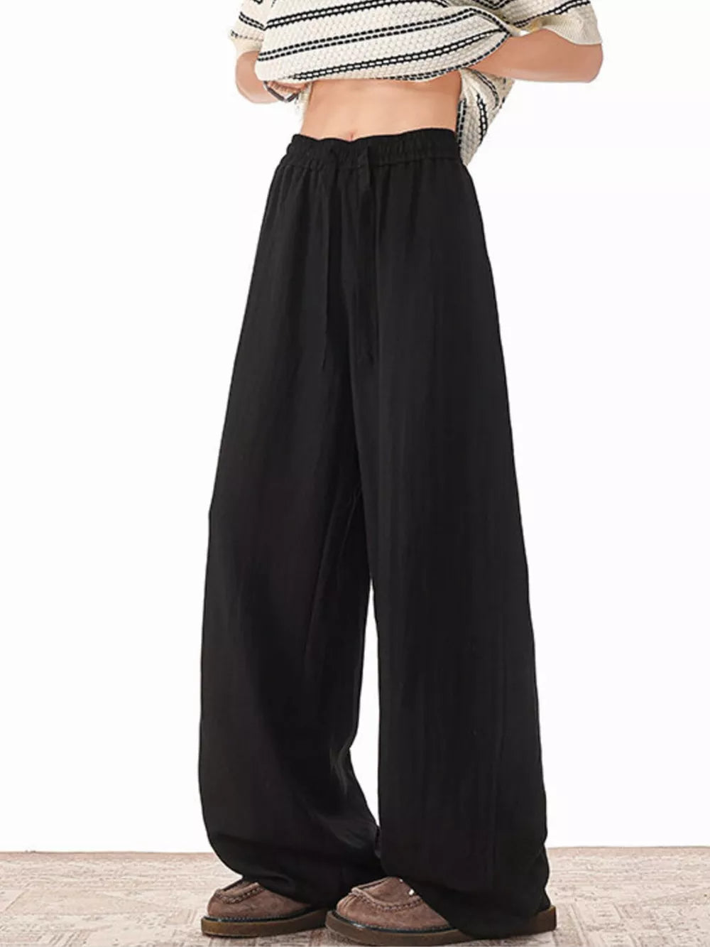 Black relaxed fit plus size drawstring sweatpants with wide legs.