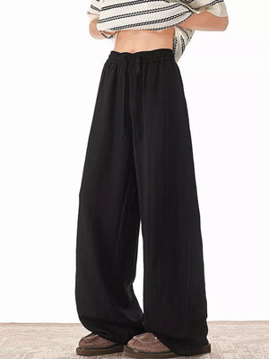 Black relaxed fit plus size drawstring sweatpants with wide legs.