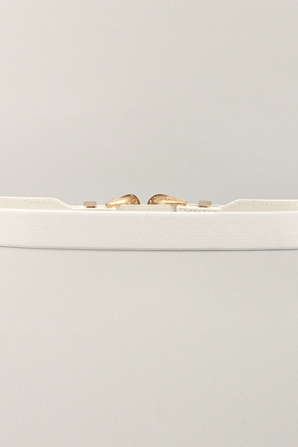 White elastic waist belt with western-style buckle and gold-tone accents