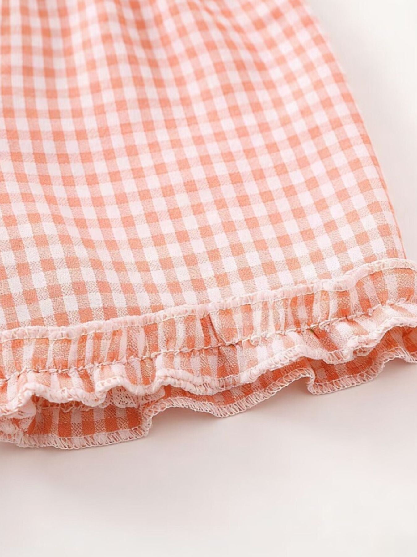 Children's cotton gingham ruffle set in blush pink.