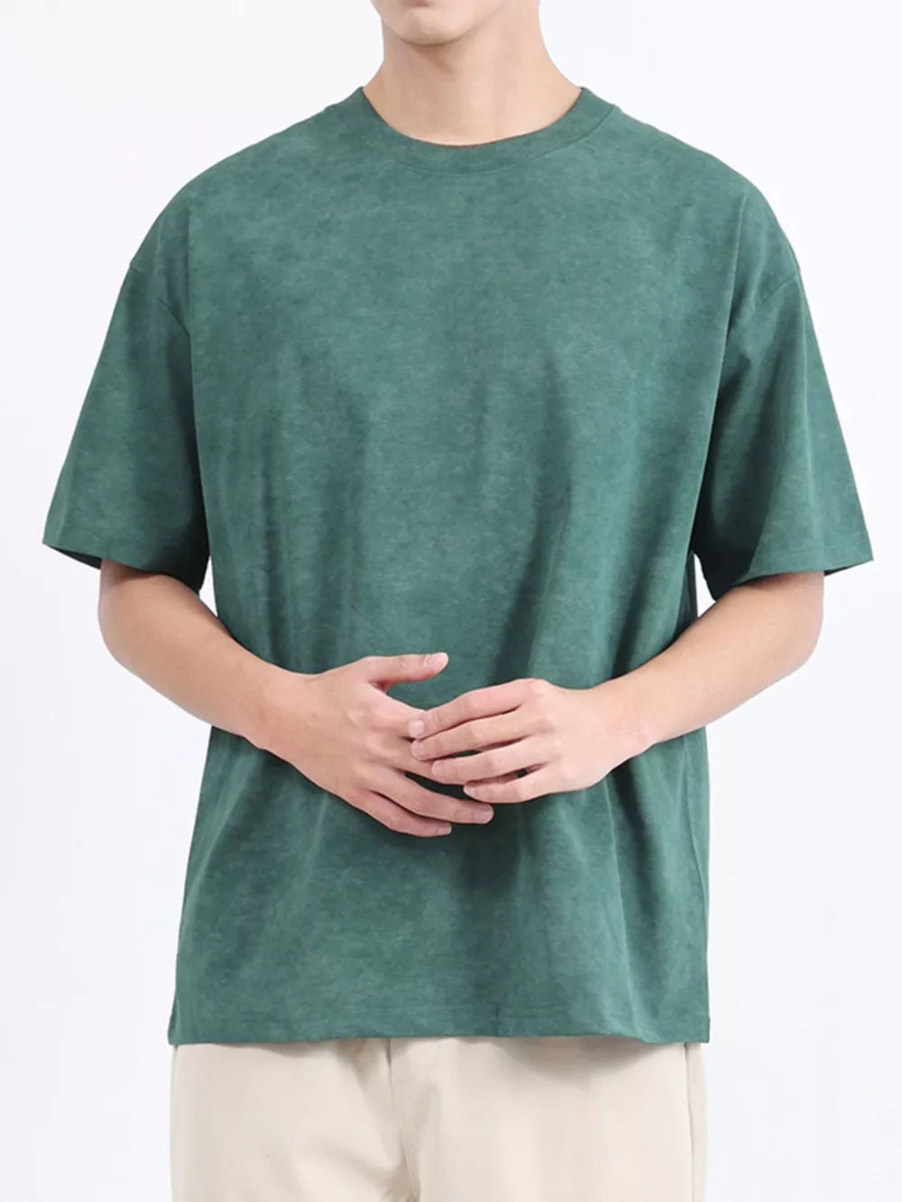 Men's dark green relaxed fit t-shirt with a subtle washed effect, crew neck, and short sleeves.