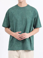 Men's dark green relaxed fit t-shirt with a subtle washed effect, crew neck, and short sleeves.