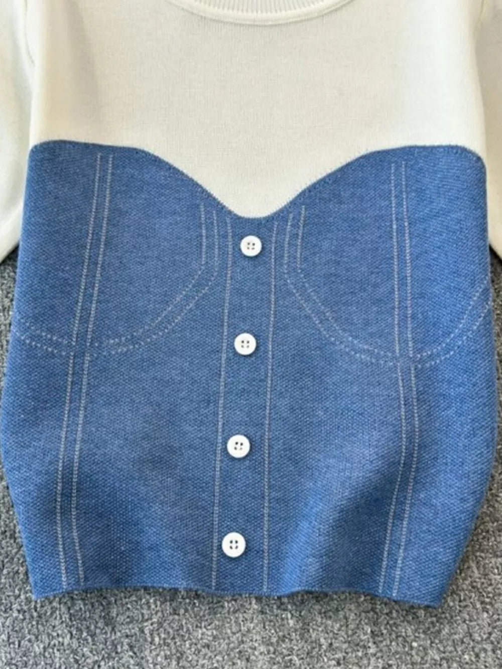 Color block knit t-shirt in white with blue denim-look bustier detail and white buttons.