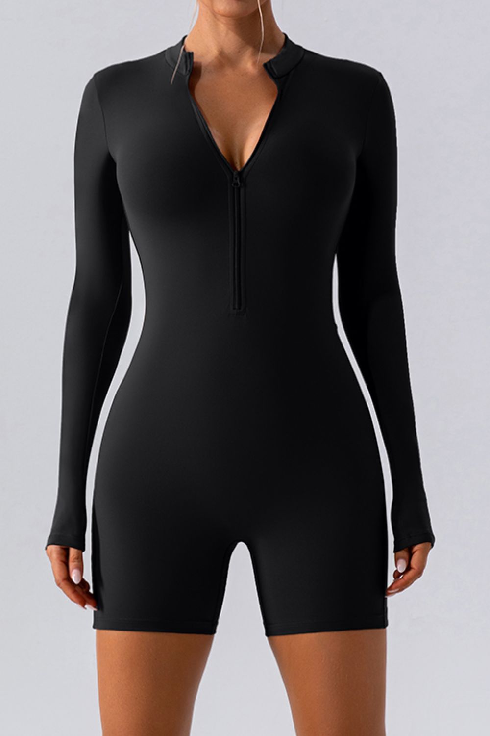Black performance romper with zip detail and long sleeves