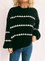 Black acrylic knit jumper with white chevron stripes, crew neck, and textured stitch.