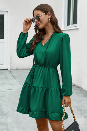 Green tiered ruffle sleeve mini dress with tie neck and elastic waist