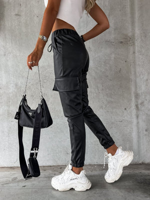 Black faux leather cargo joggers with elasticated waist and cuffed ankles.