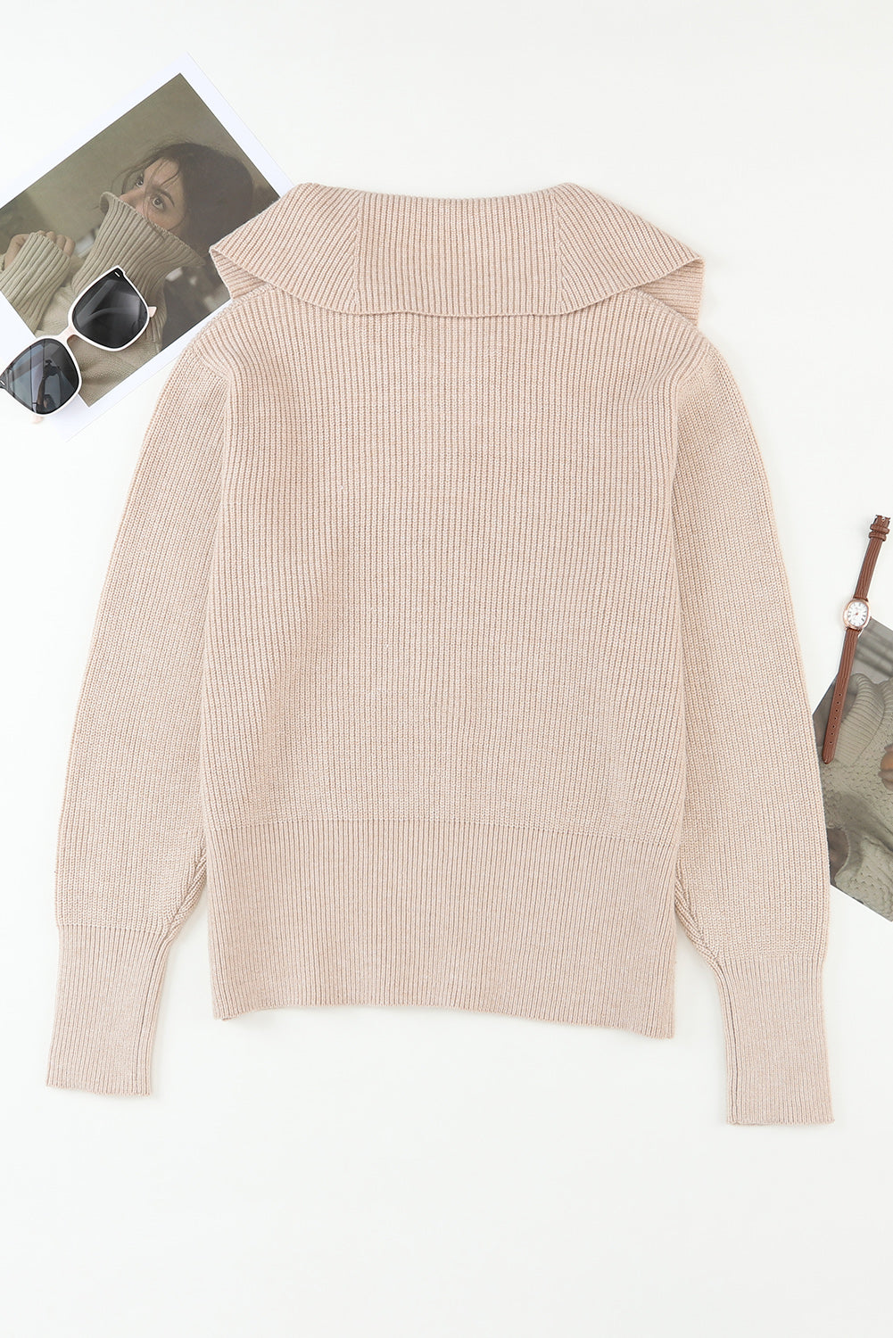 Beige ribbed knit cardigan with shawl collar and long sleeves.