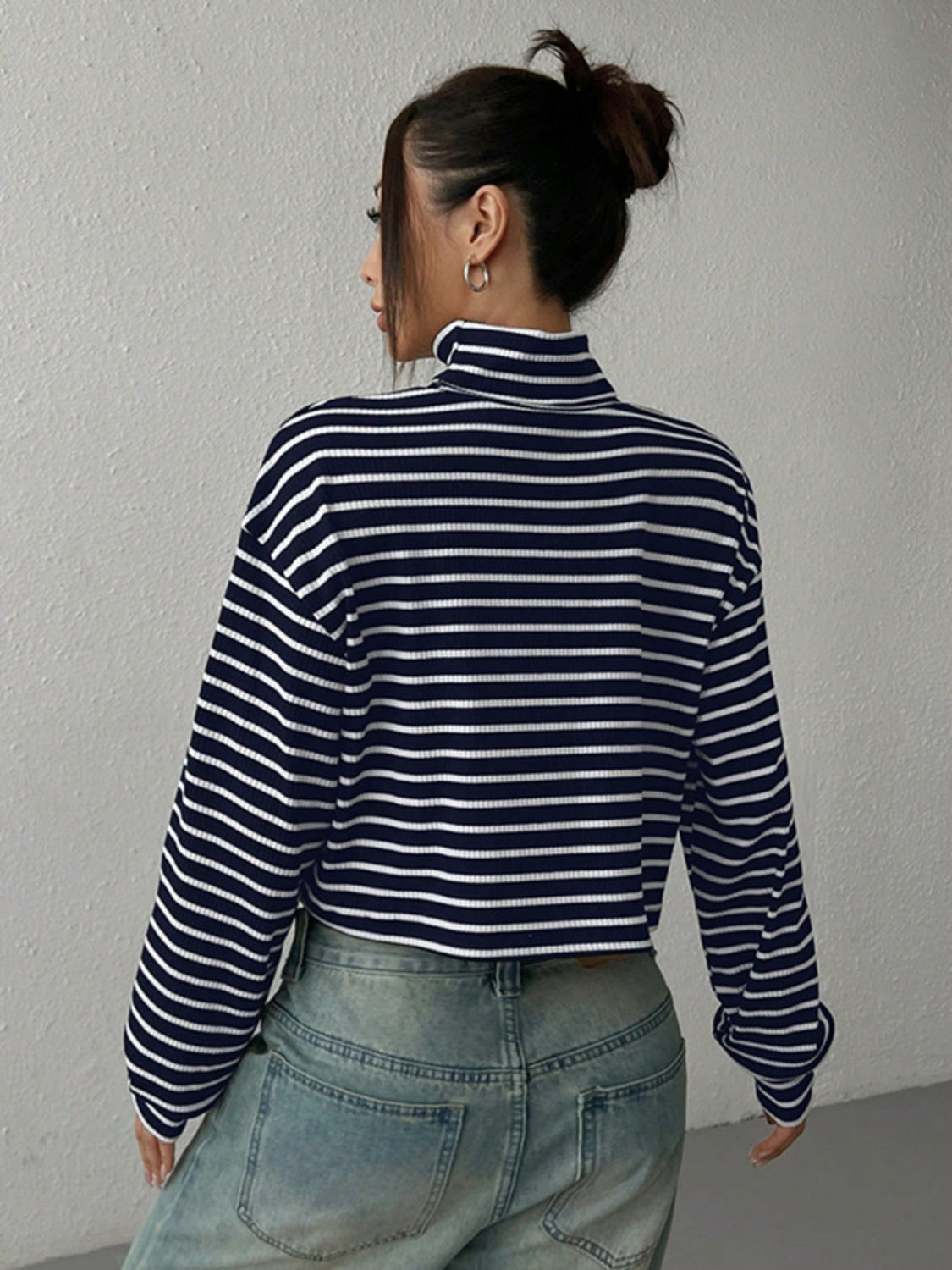 Striped cropped ribbed turtleneck sweater with a high neck and long sleeves.