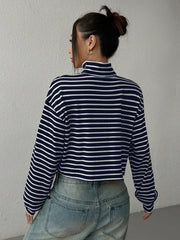Striped cropped ribbed turtleneck sweater with a high neck and long sleeves.