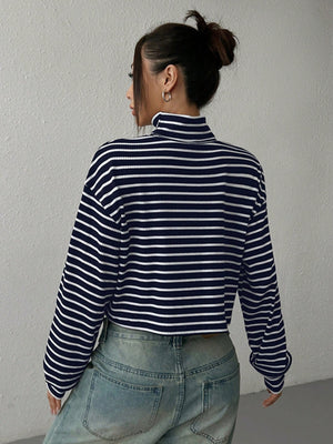 Striped cropped ribbed turtleneck sweater with a high neck and long sleeves.