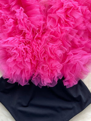 Ruffled V-neck bodysuit in black with a bright pink tulle overlay and lace trim.