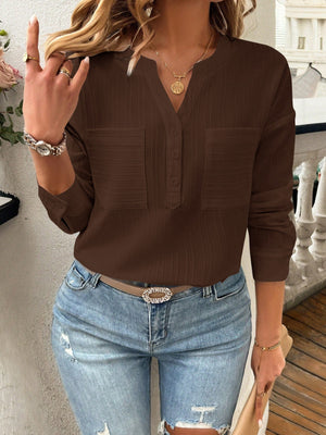 Chocolate textured henley blouse with two chest pockets and button placket.