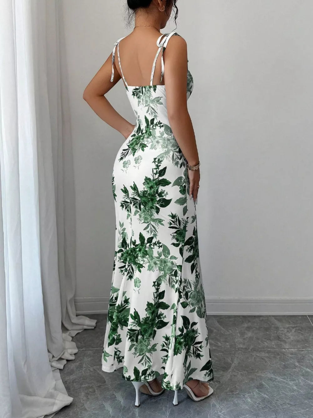 Floral print maxi dress with tie straps and a fitted silhouette.