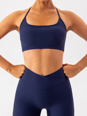Dark blue ribbed halterneck active bra with a square neckline.