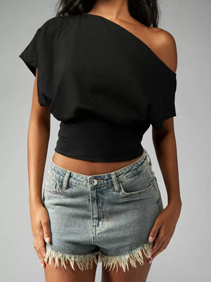 Black asymmetrical crop t-shirt with draped fit and short sleeves.