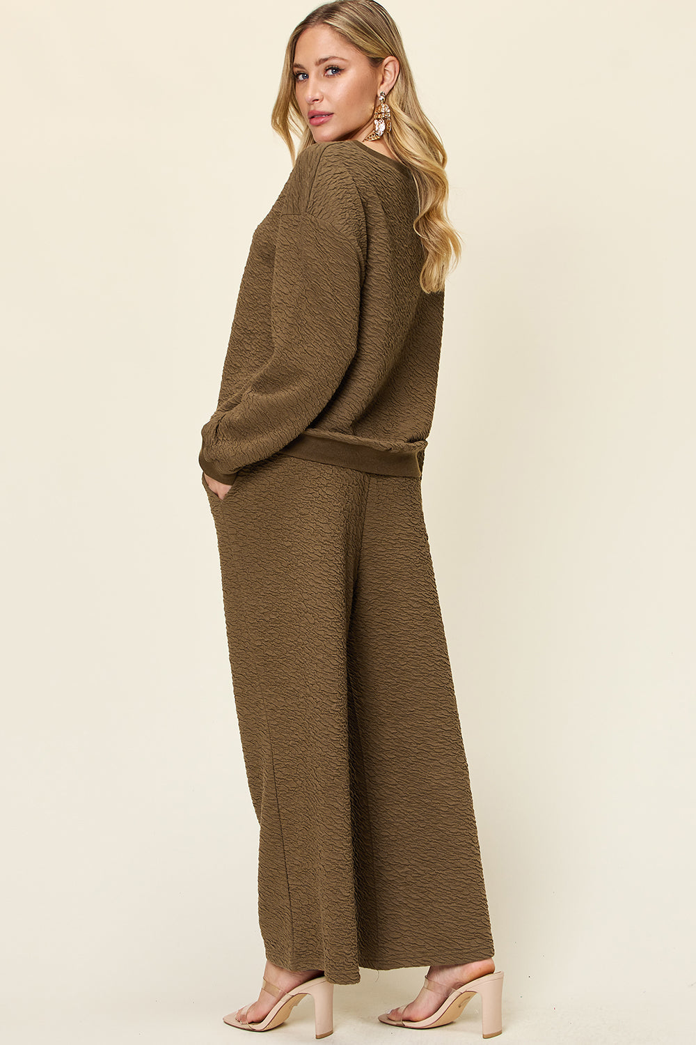 Textured lounge set in olive green with wide leg pants and crewneck sweatshirt.