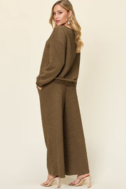 Textured lounge set in olive green with wide leg pants and crewneck sweatshirt.