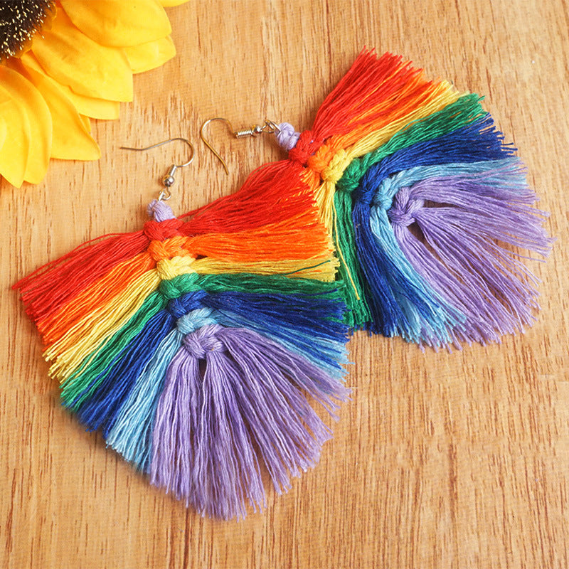 Rainbow fan tassel earrings with macrame detail and hook closure.