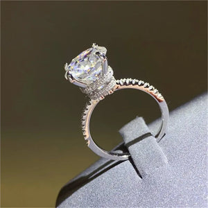Sterling silver ring with a large solitaire diamond and pave band.