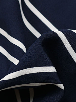 Dark blue palazzo trousers with white vertical stripes and a slit leg detail.