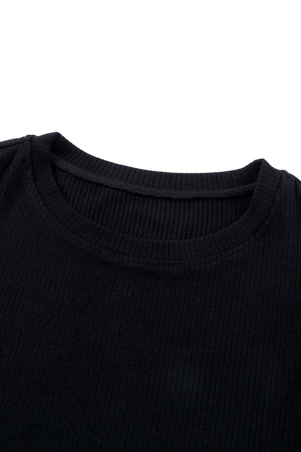Black ribbed knit blouse with crew neck and dot mesh sleeves detail