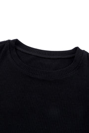 Black ribbed knit blouse with crew neck and dot mesh sleeves detail