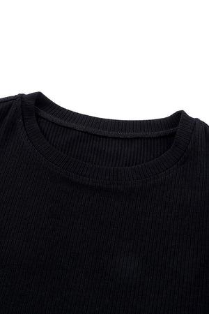Black ribbed knit blouse with crew neck and dot mesh sleeves detail