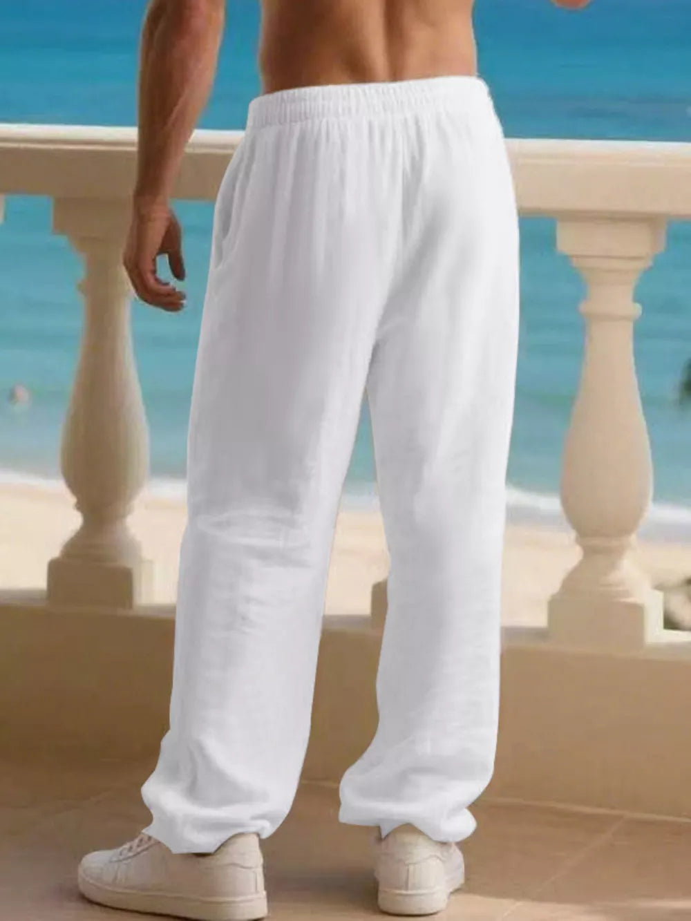 Men's white linen drawstring joggers with a relaxed fit.