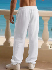 Men's white linen drawstring joggers with a relaxed fit.