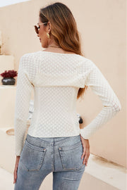 Cream open-knit bolero sleeve top with diamond pattern detail.