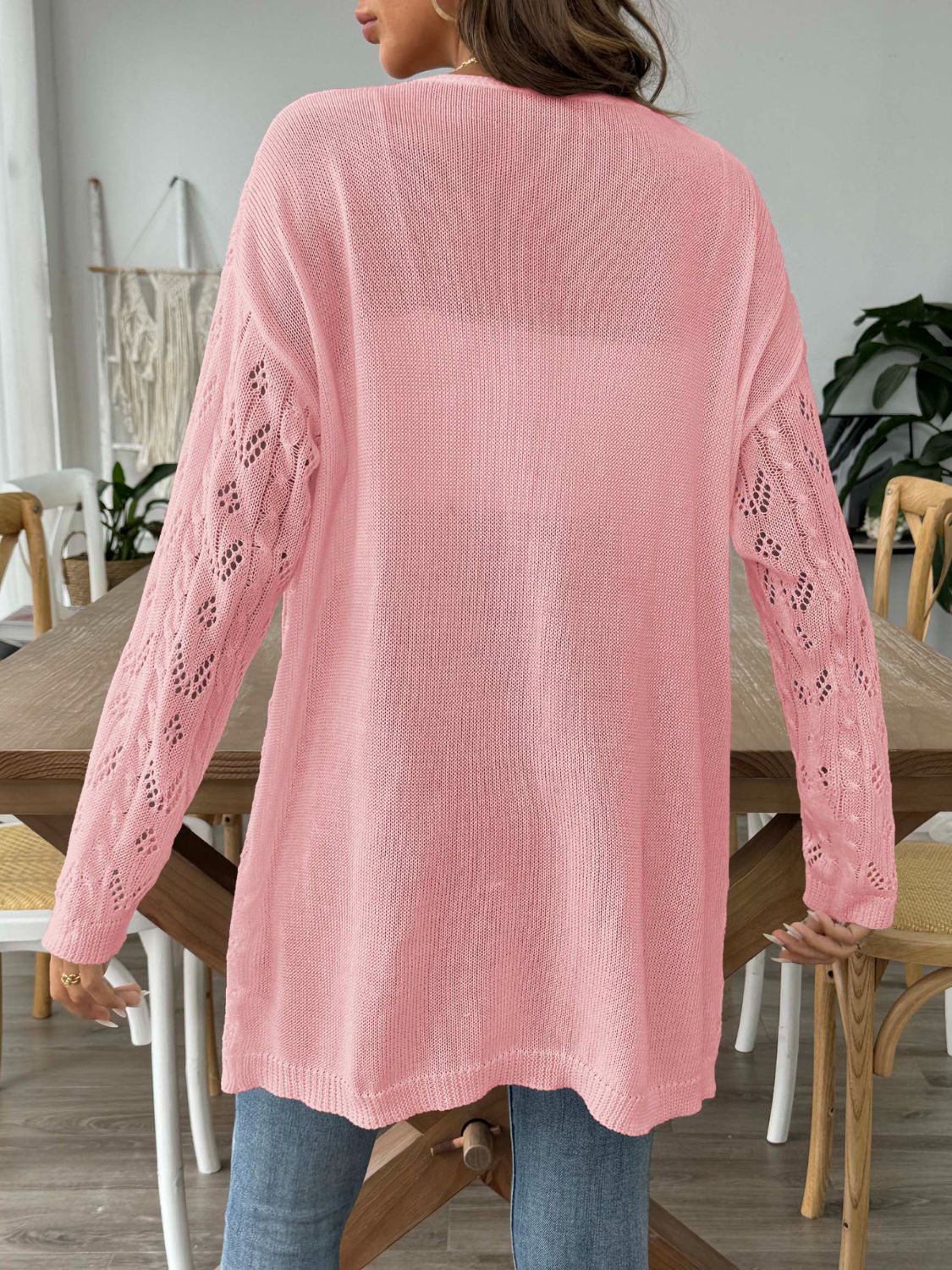 Pink openwork diamond knit duster cardigan with long sleeves and a relaxed fit.