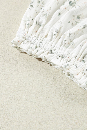 White floral smocked bodice jumpsuit with ruffled hem detail