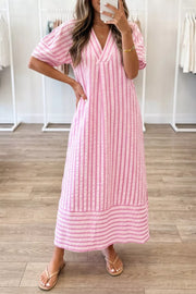 Pink striped V-neck midi dress with short sleeves and a tiered hem.